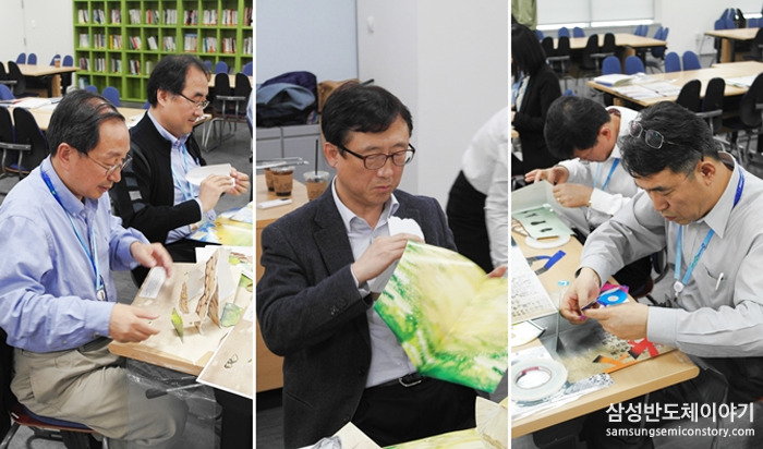 집중하여 팝업북을 만드는 임원진들